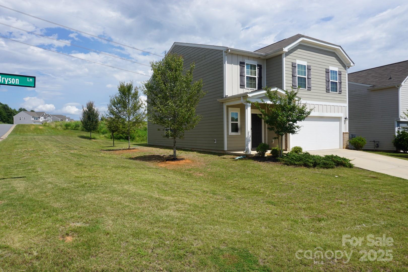 1276 Bryson Lane Denver, NC 28037 - Photo 2 of 16 a front view of a house with garden
