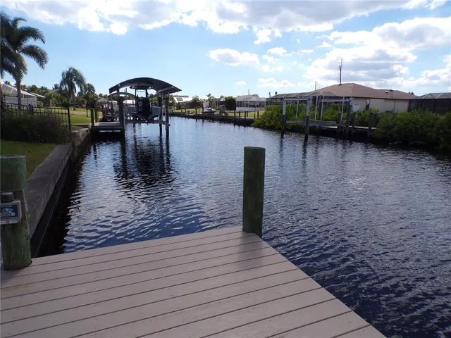 a view of a backyard with a table and chair under an umbrella