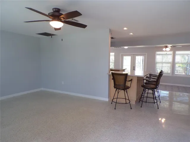 a view of a dining room with furniture and a chandelier fan