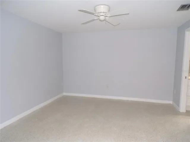 a view of an empty room and a window