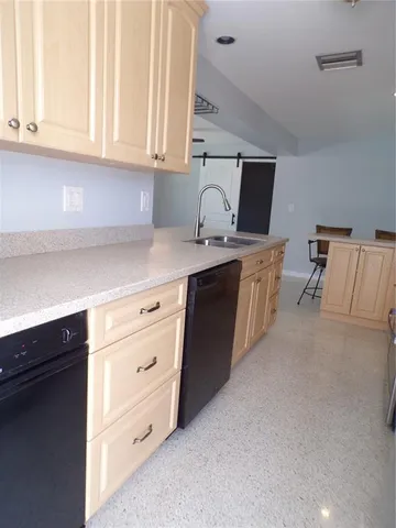 a bathroom with a granite countertop sink a toilet and shower