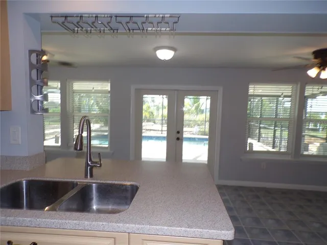 a kitchen with a sink and large window