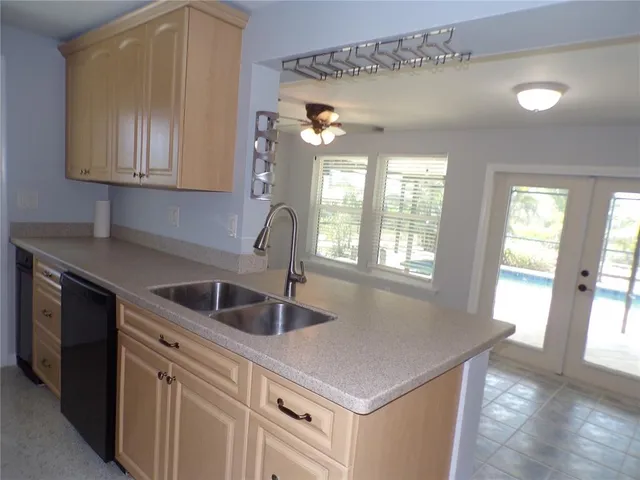 a kitchen with granite countertop a sink and cabinets