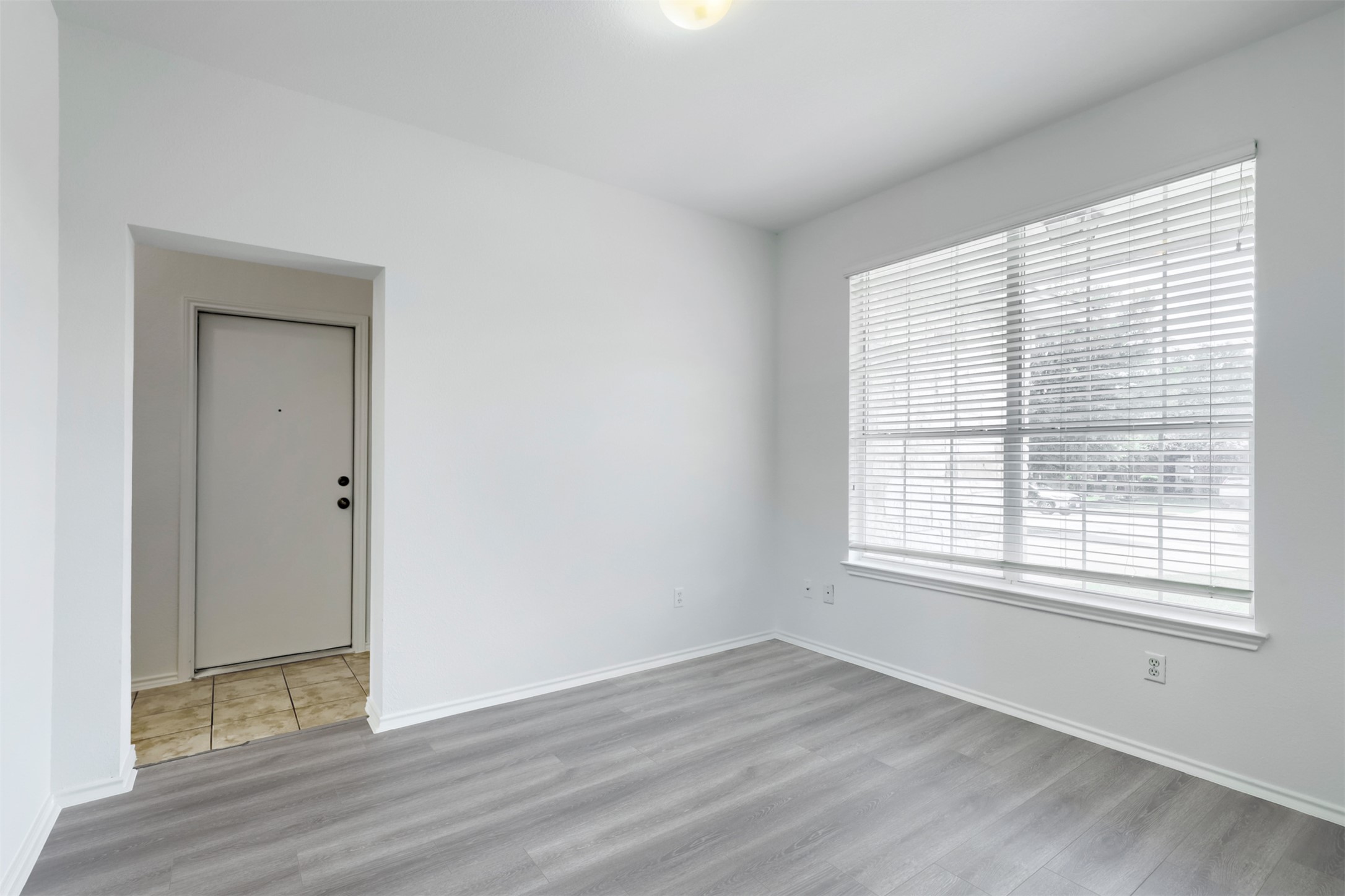 4125 Pebble Ridge Cove Round Rock, TX 78681 - Photo 6 of 30 Laminate wood flooring and a large window create a bright, inviting space.