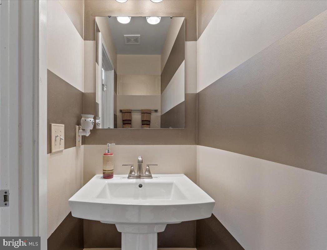 18060 Red Cedar Road Dumfries, VA 22026 - Photo 14 of 39 a bathroom with a sink and a mirror