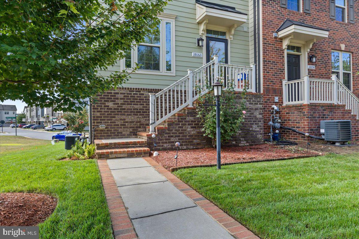 18060 Red Cedar Road Dumfries, VA 22026 - Photo 3 of 39 a view of a house with a yard and a large tree