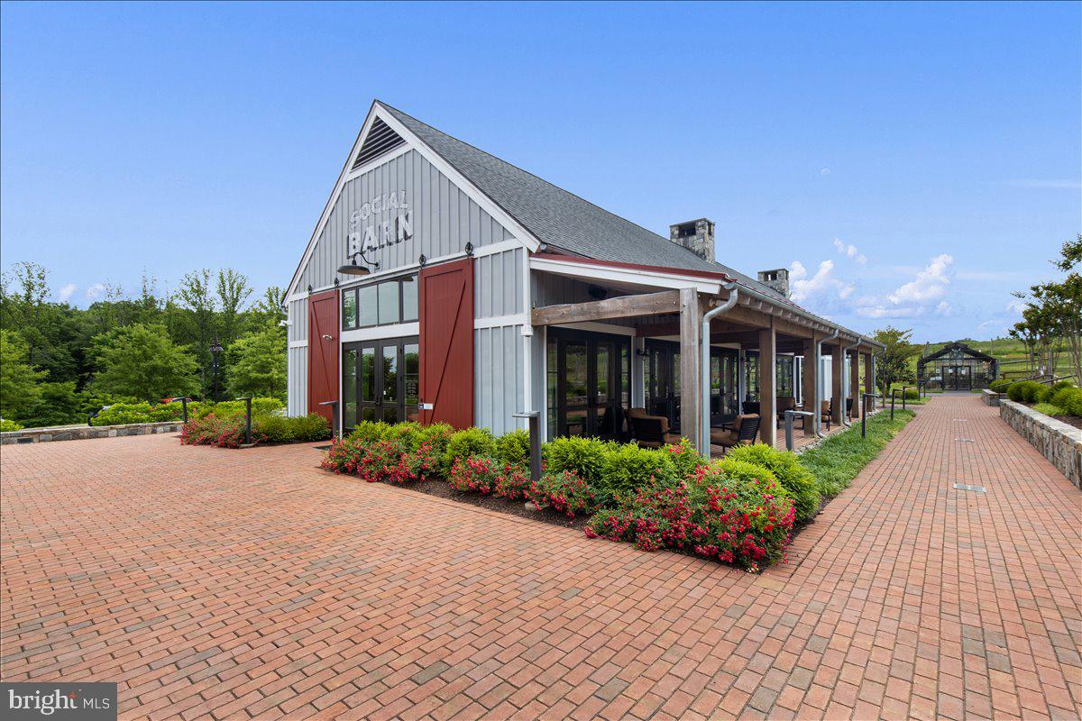 18060 Red Cedar Road Dumfries, VA 22026 - Photo 34 of 39 a front view of a house with garden