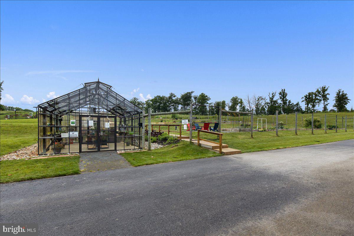 18060 Red Cedar Road Dumfries, VA 22026 - Photo 35 of 39 a view of a house with big yard and a large tree