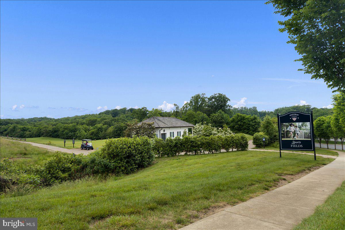18060 Red Cedar Road Dumfries, VA 22026 - Photo 38 of 39 a view of a grassy field with trees