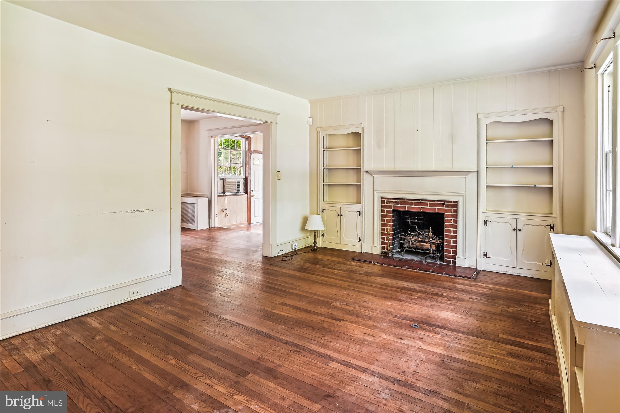 6211 Pinehurst Road Baltimore, MD 21212 - Photo 15 of 37 a view of a livingroom with wooden floor and a fireplace