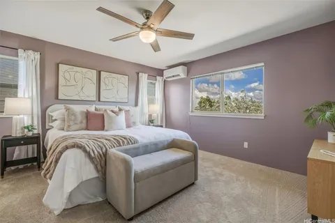a spacious bedroom with a large bed and a chandelier