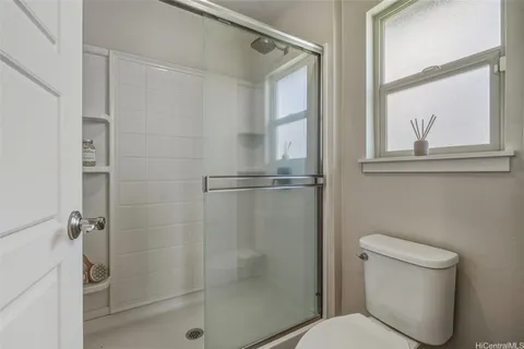 a bathroom with a toilet and a shower