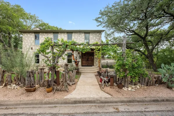 a view of a house with potted plants