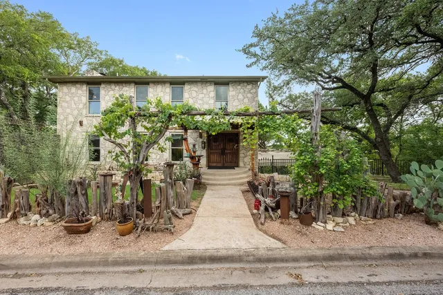 a view of a house with potted plants