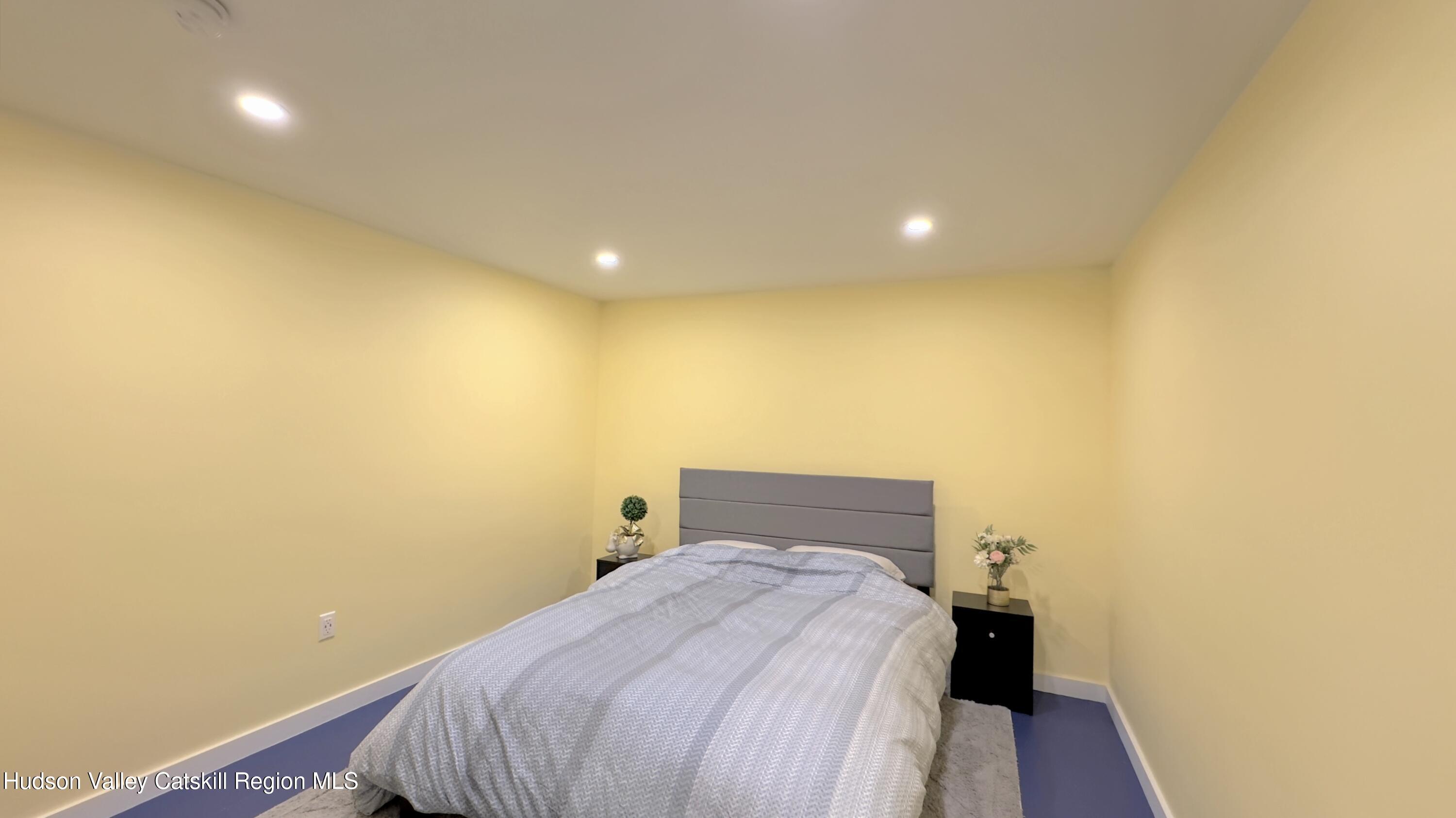 3223 Sleepy Hollow Road Athens, NY 12015 - Photo 29 of 55 a bedroom with a bed and wooden floor