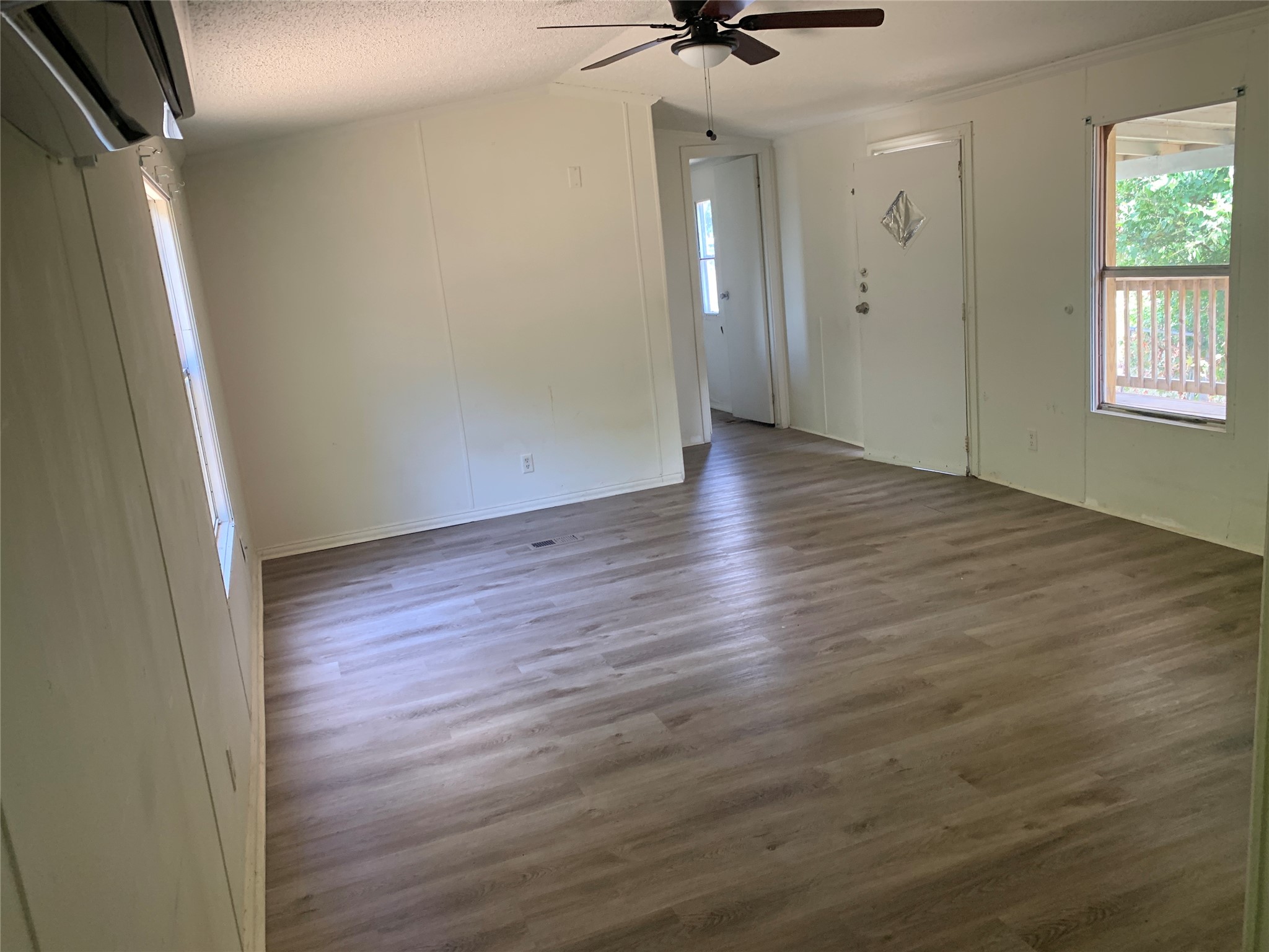 9903 Cheryl Lynn Road Austin, TX 78747 - Photo 5 of 13 A spacious room offers new vinyl plank flooring and ample natural light.