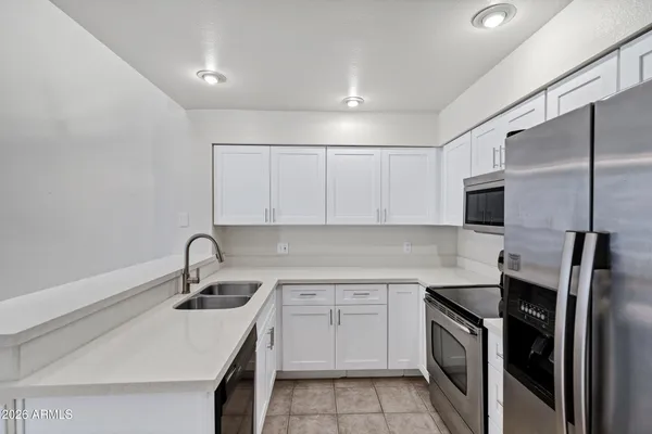a spacious bathroom with a toilet sink and mirror