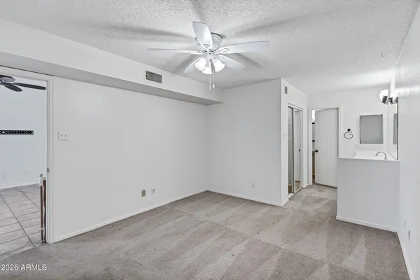 a view of walk in closet with empty racks
