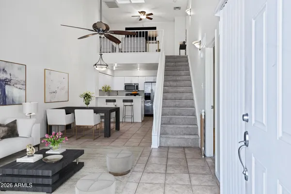a view of a hallway with closet and a window