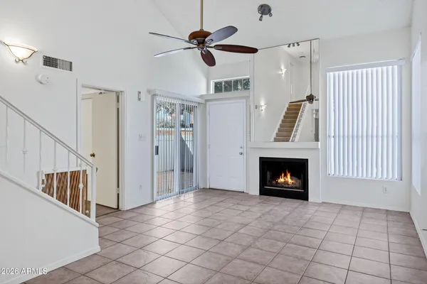 a kitchen with a sink a fireplace and cabinets