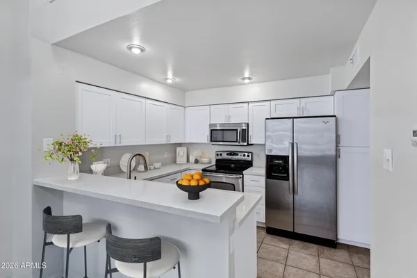 a kitchen with a sink cabinets and stainless steel appliances