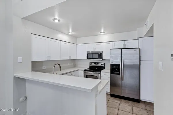 a view of a kitchen with a sink and a chandelier fan
