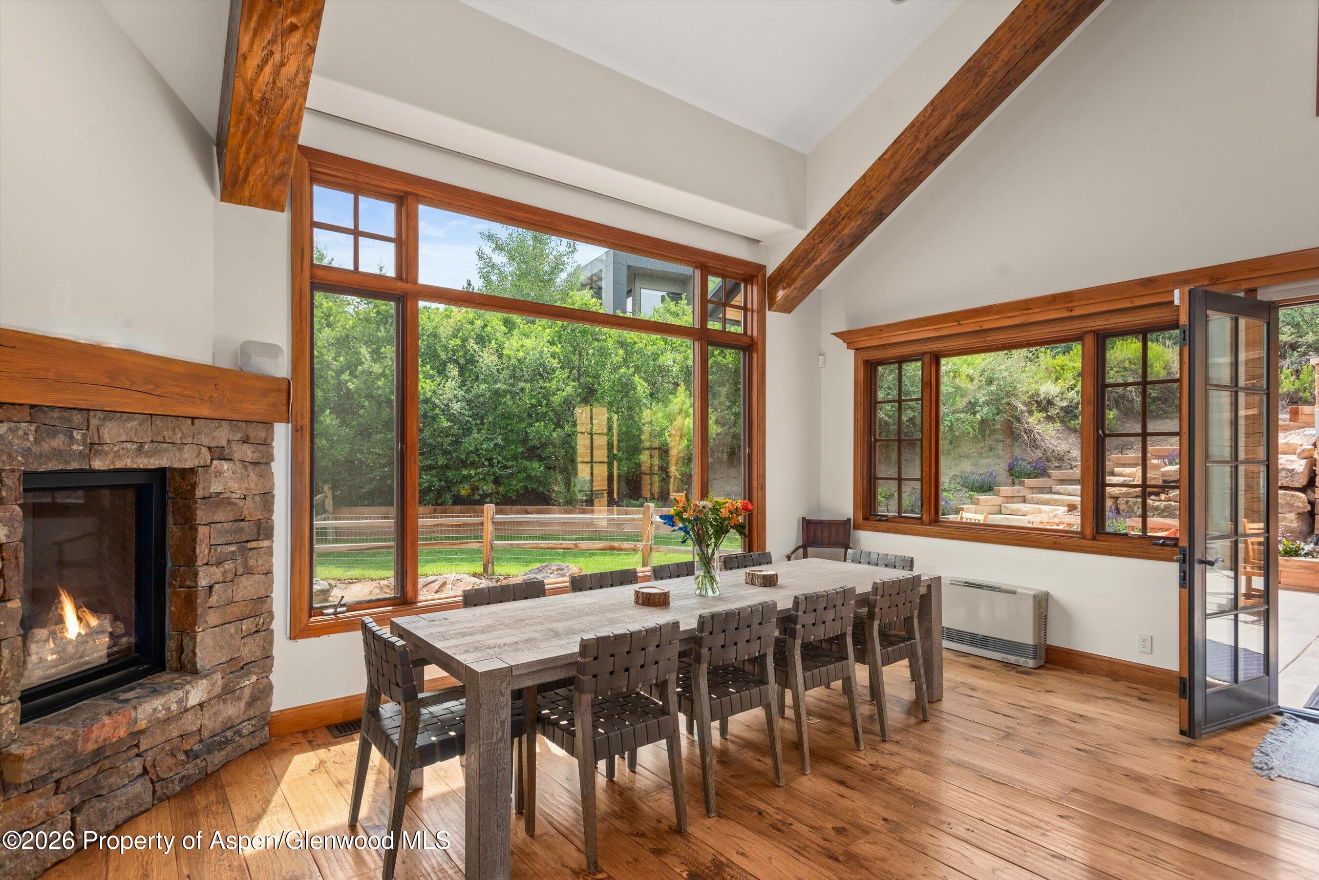 701 Brush Creek Road Aspen, CO 81611 - Photo 11 of 18 a view of a dining room with furniture window and wooden floor