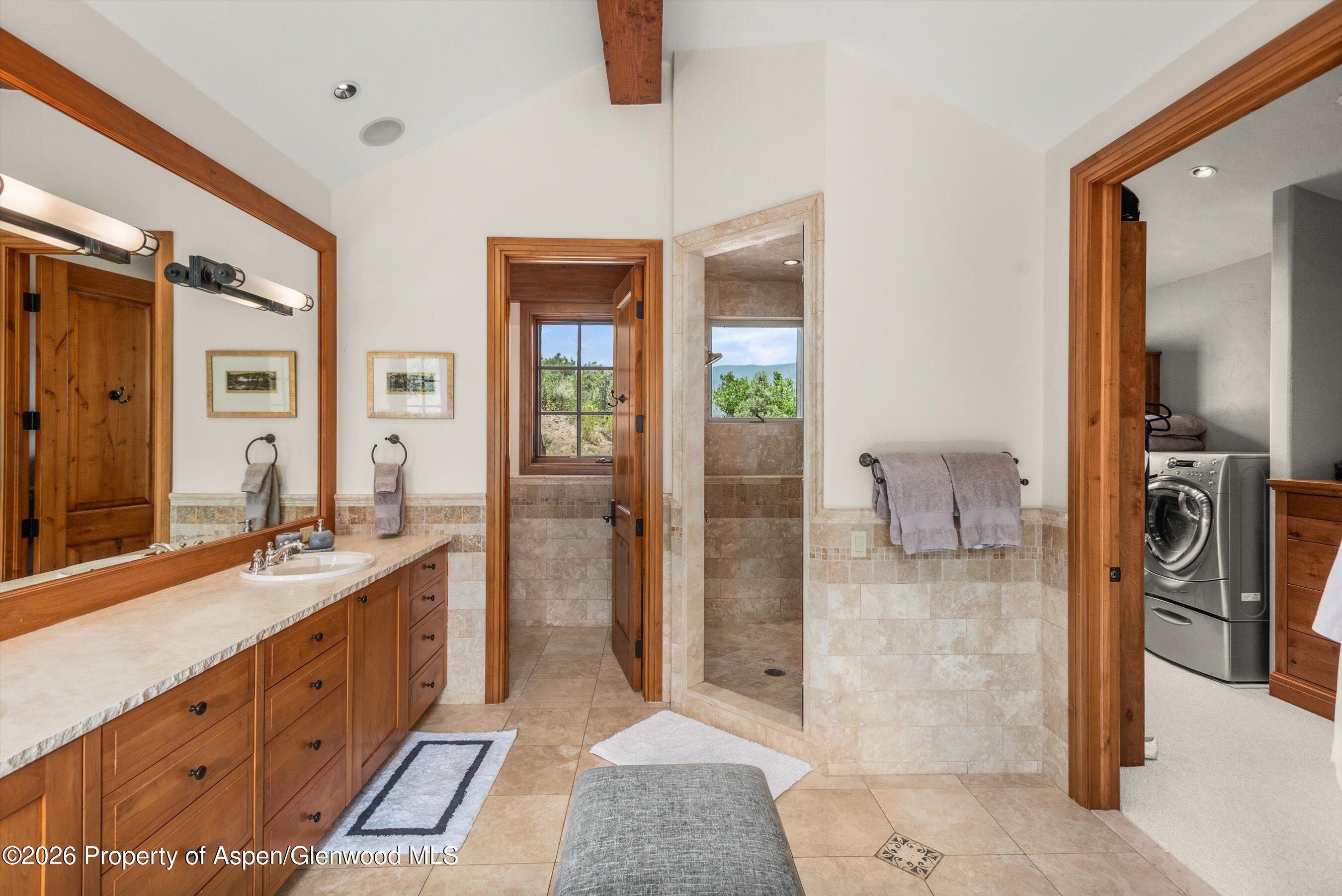 701 Brush Creek Road Aspen, CO 81611 - Photo 13 of 18 a spacious en suite bathroom with a granite countertop sink and a mirror