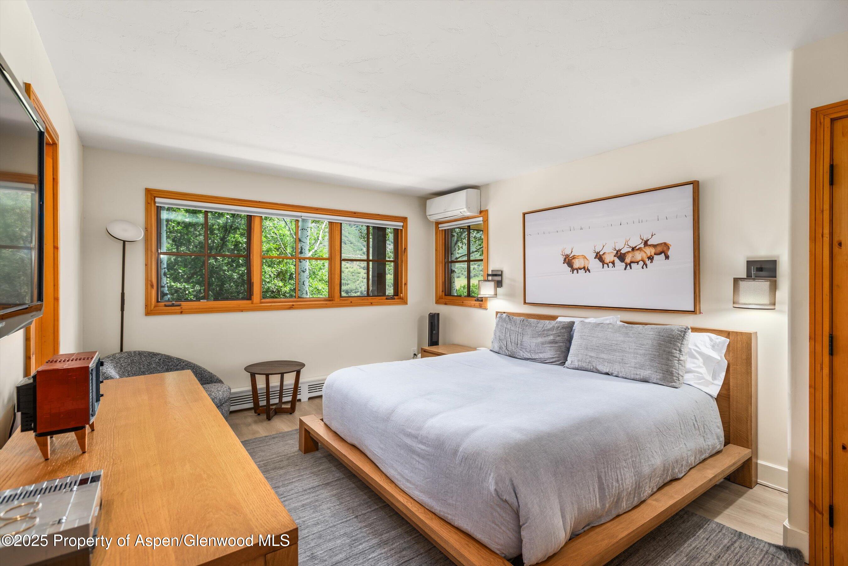 701 Brush Creek Road Aspen, CO 81611 - Photo 16 of 18 a bedroom with a large bed and a large window