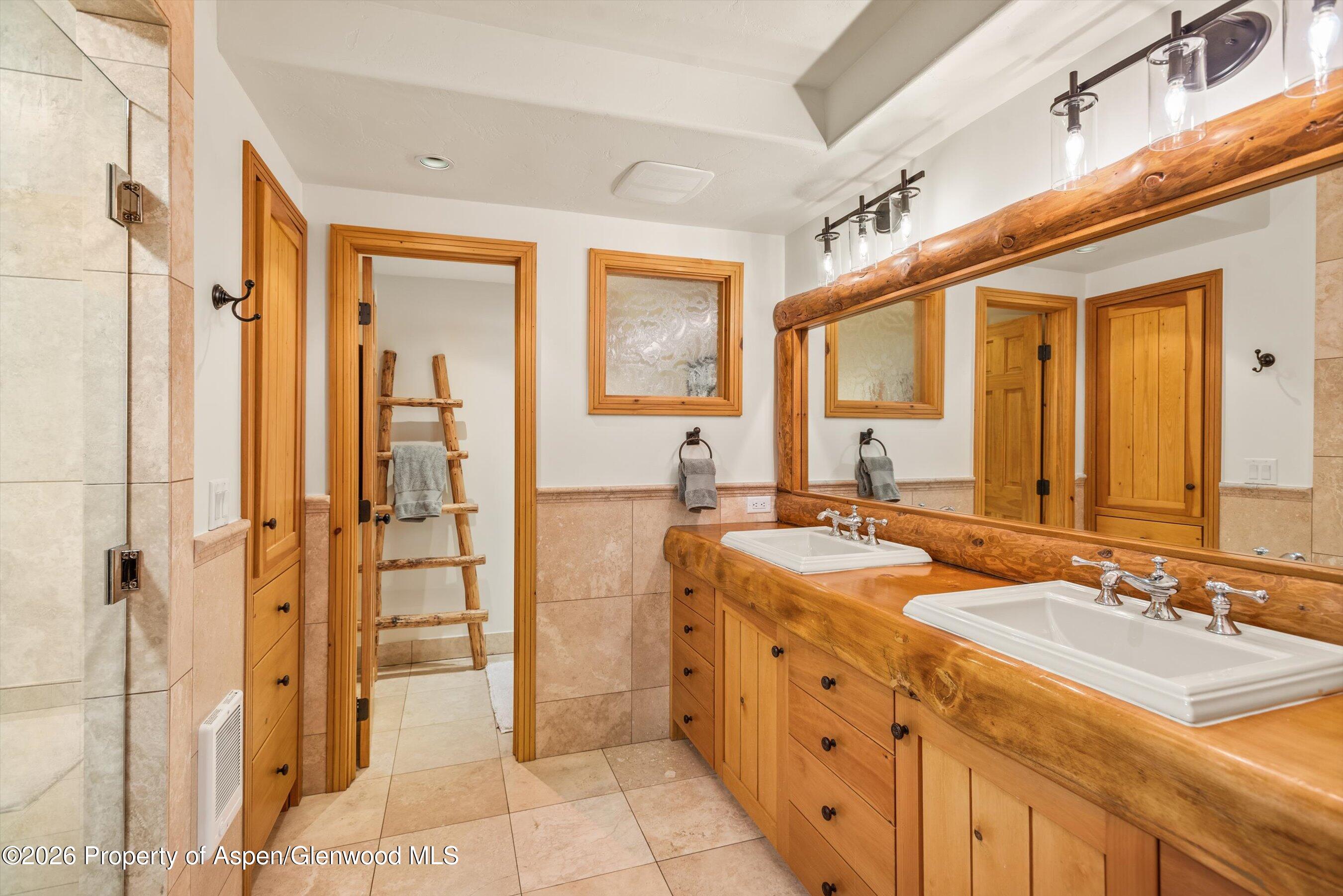 701 Brush Creek Road Aspen, CO 81611 - Photo 18 of 18 a spacious bathroom with a double vanity sink mirror and shower