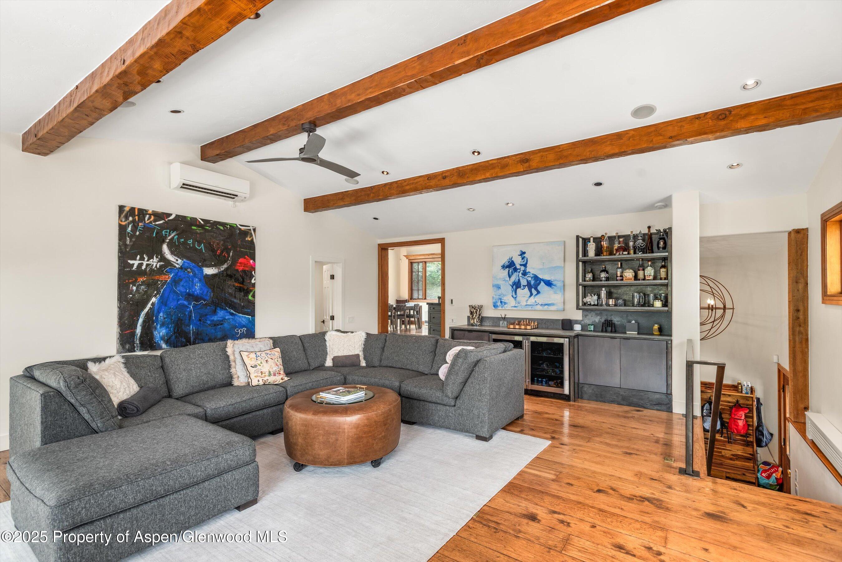701 Brush Creek Road Aspen, CO 81611 - Photo 7 of 18 a living room with fireplace furniture and a flat screen tv