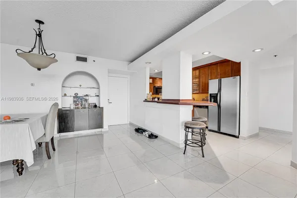 a kitchen with stainless steel appliances a refrigerator and microwave