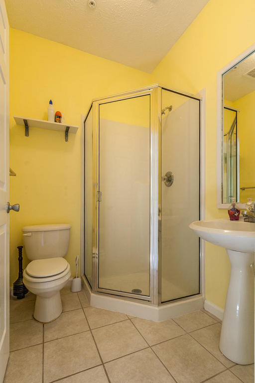 34 Heron's Watch Way, Unit 1304 Santa Rosa Beach, FL 32459 - Photo 13 of 15 a bathroom with a granite countertop sink toilet and shower