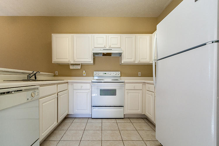 34 Heron's Watch Way, Unit 1304 Santa Rosa Beach, FL 32459 - Photo 7 of 15 a kitchen with a stove sink and cabinets