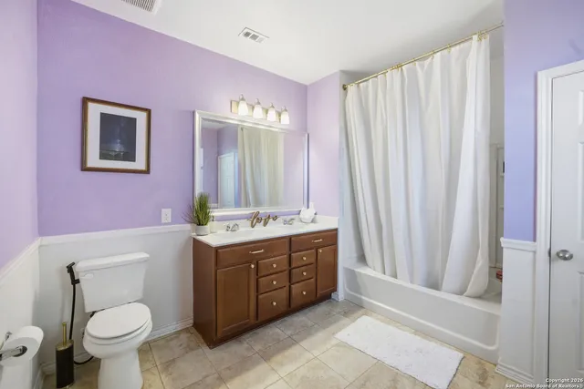 a bathroom with a sink vanity mirror and toilet