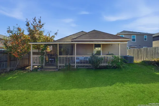 a view of a house with a yard and deck