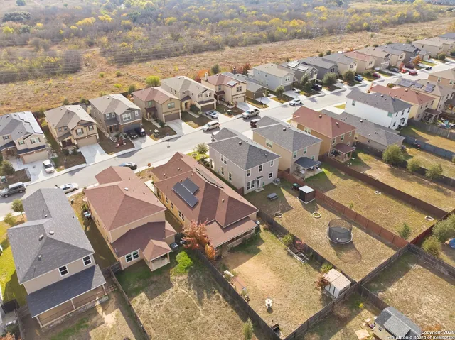 an aerial view of residential houses with outdoor space