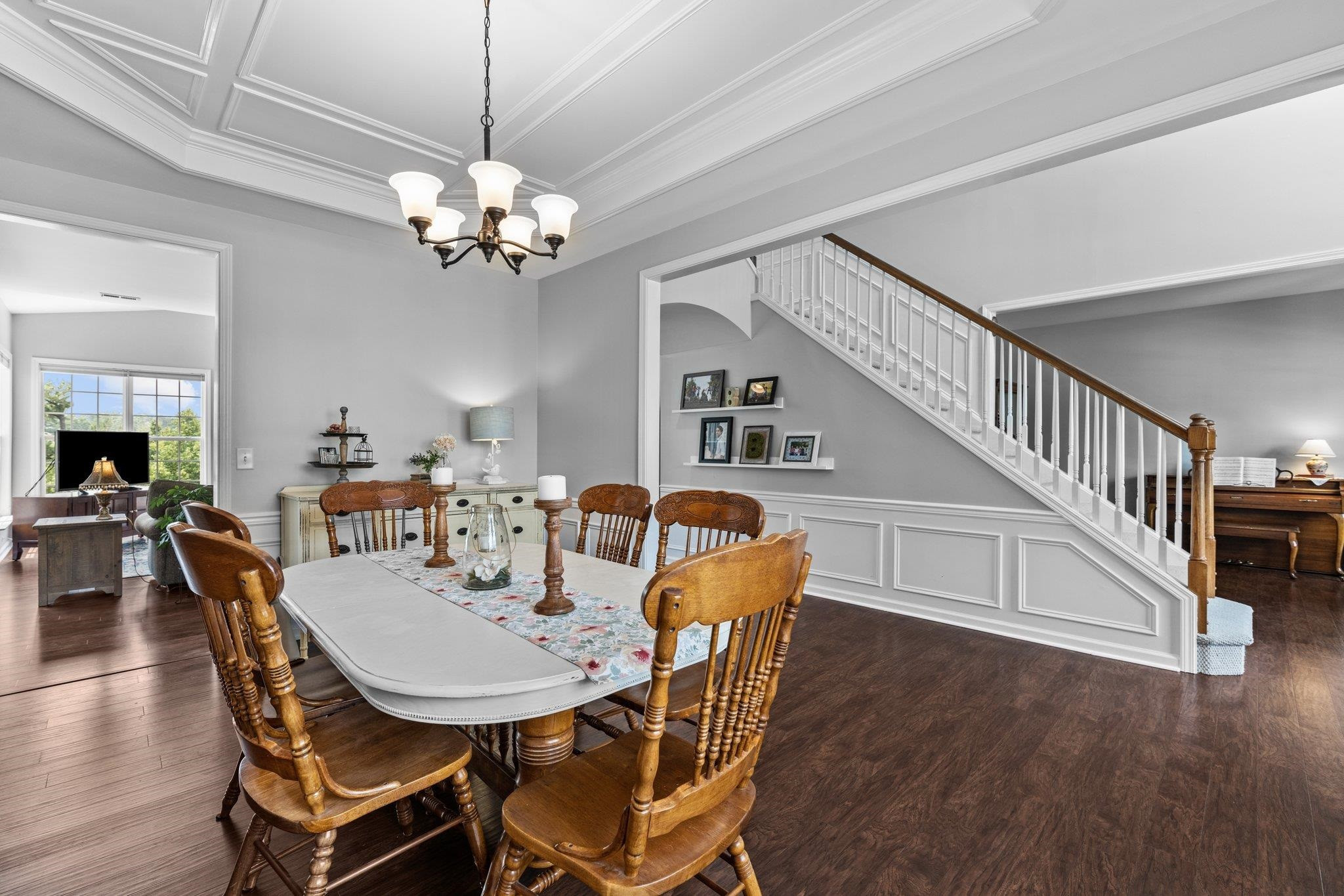 7509 Silver View Lane Raleigh, NC 27613 - Photo 10 of 39 a view of a dining room with furniture a chandelier and wooden floor