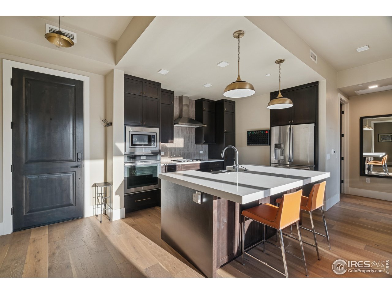 302 North Meldrum Street, Unit 304 Fort Collins, CO 80521 - Photo 9 of 31 a kitchen with stainless steel appliances kitchen island a dining table and chairs