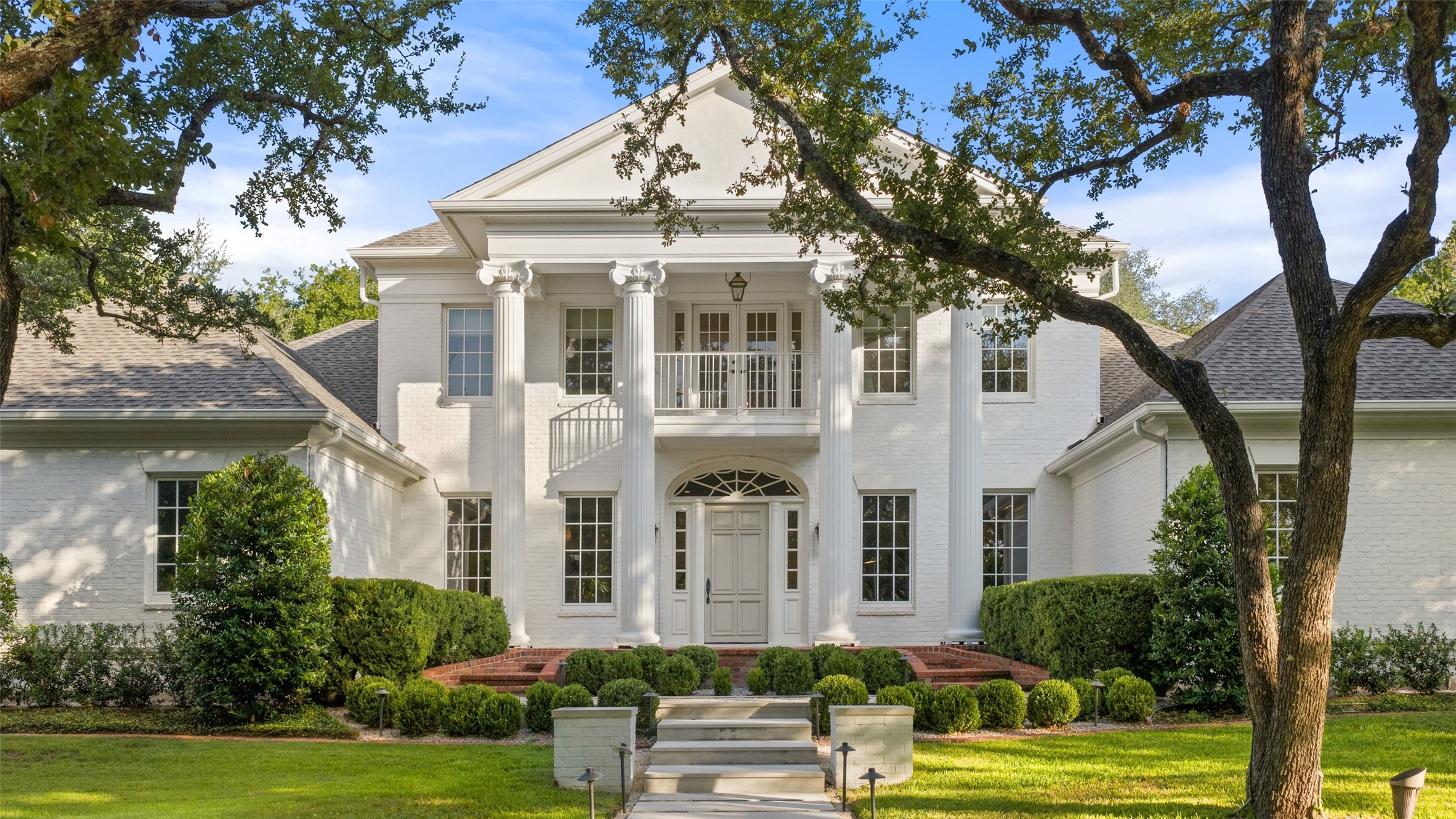 4201 Green Cliffs Road Austin, TX 78746 - Photo 1 of 40 Stately columns, a sweeping front lawn, and mature oak trees set a welcoming tone as you approach this gated Green Park estate in Westlake