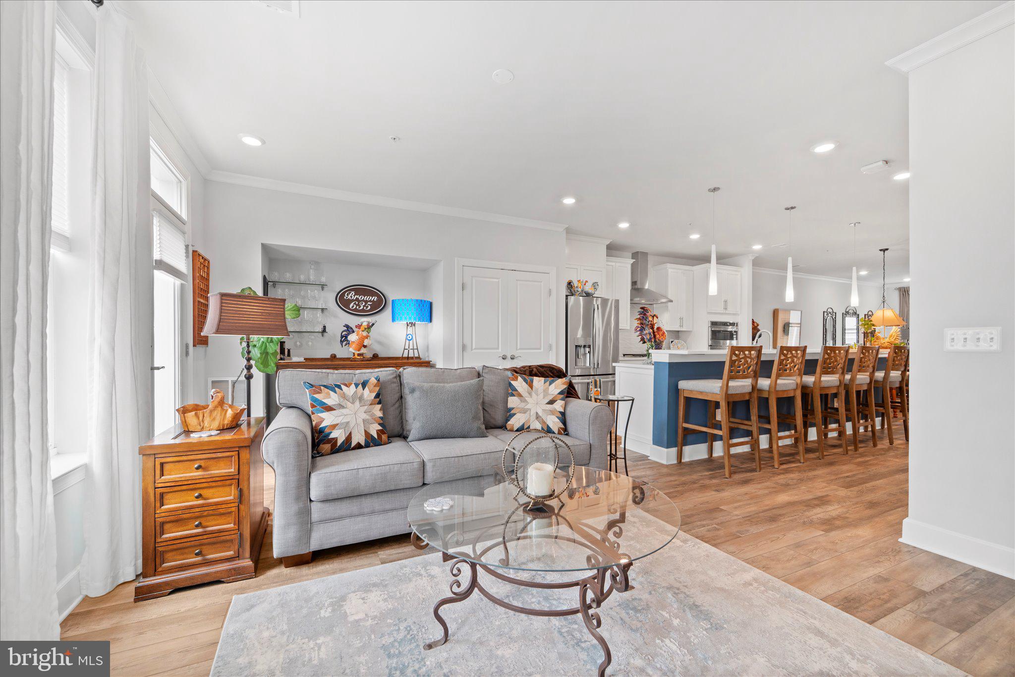 45206 Lettermore Square Sterling, VA 20166 - Photo 16 of 42 a living room with furniture and kitchen view
