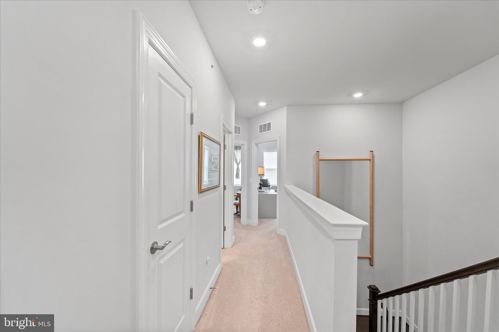 45206 Lettermore Square Sterling, VA 20166 - Photo 21 of 42 a hallway with white walls and stairs