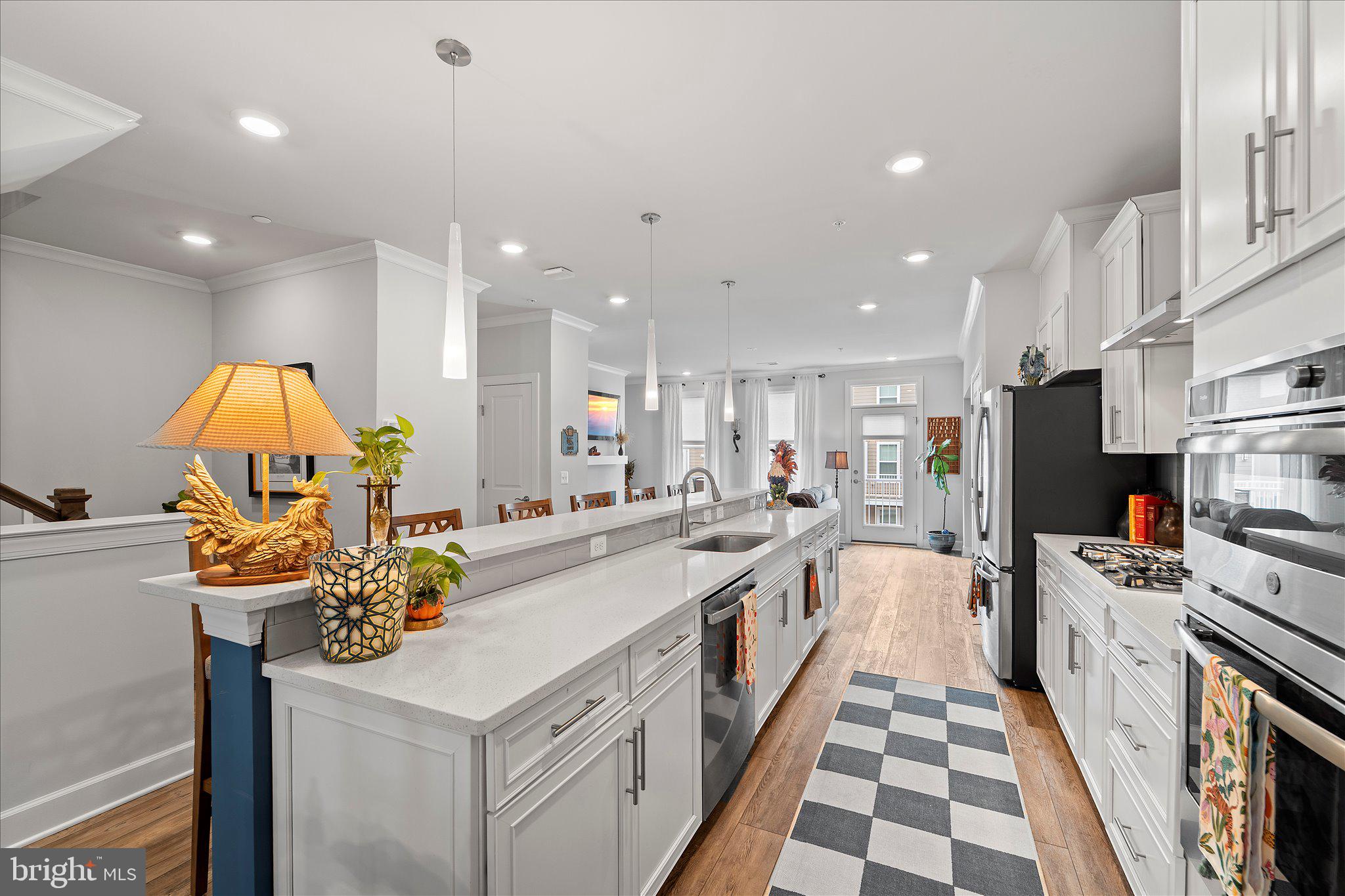 45206 Lettermore Square Sterling, VA 20166 - Photo 7 of 42 a kitchen with stainless steel appliances kitchen island granite countertop a sink and cabinets