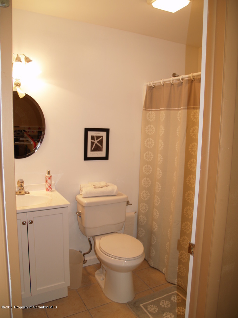 209 Ridgewood Circle Lake Ariel, PA 18436 - Photo 15 of 16 a bathroom with a toilet a sink and vanity