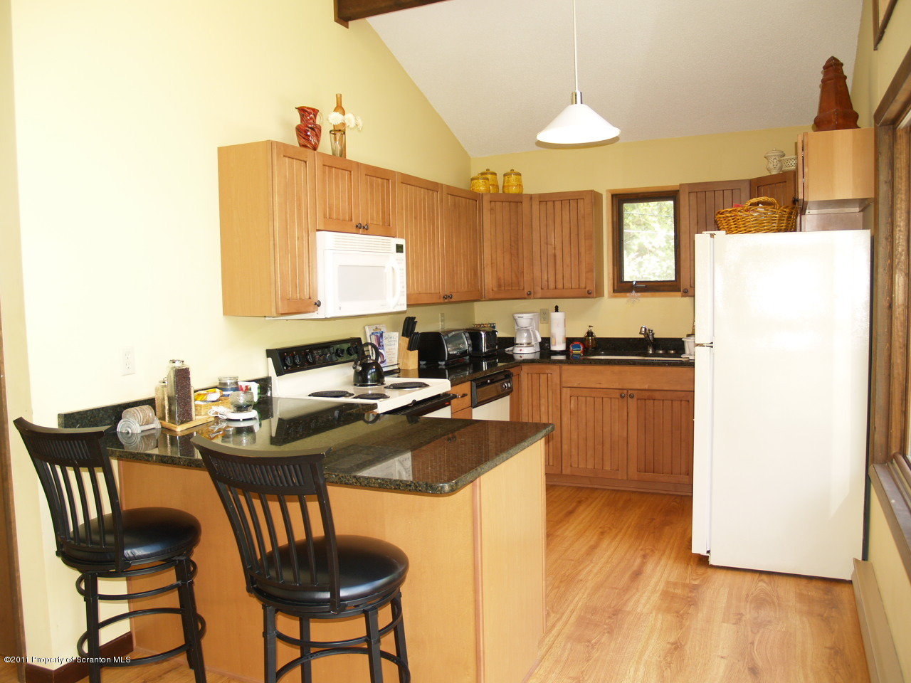 209 Ridgewood Circle Lake Ariel, PA 18436 - Photo 6 of 16 a kitchen with sink refrigerator dining table and chairs