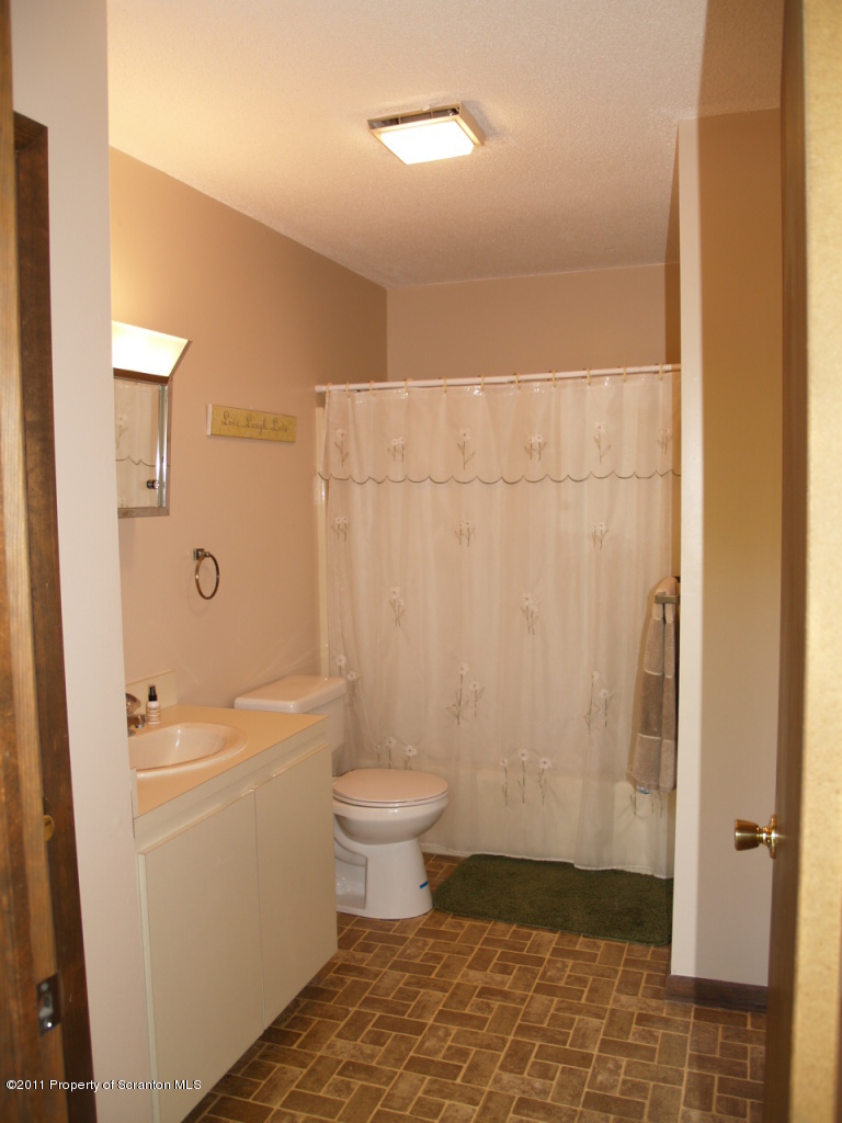 209 Ridgewood Circle Lake Ariel, PA 18436 - Photo 10 of 16 a bathroom with a toilet a sink and shower