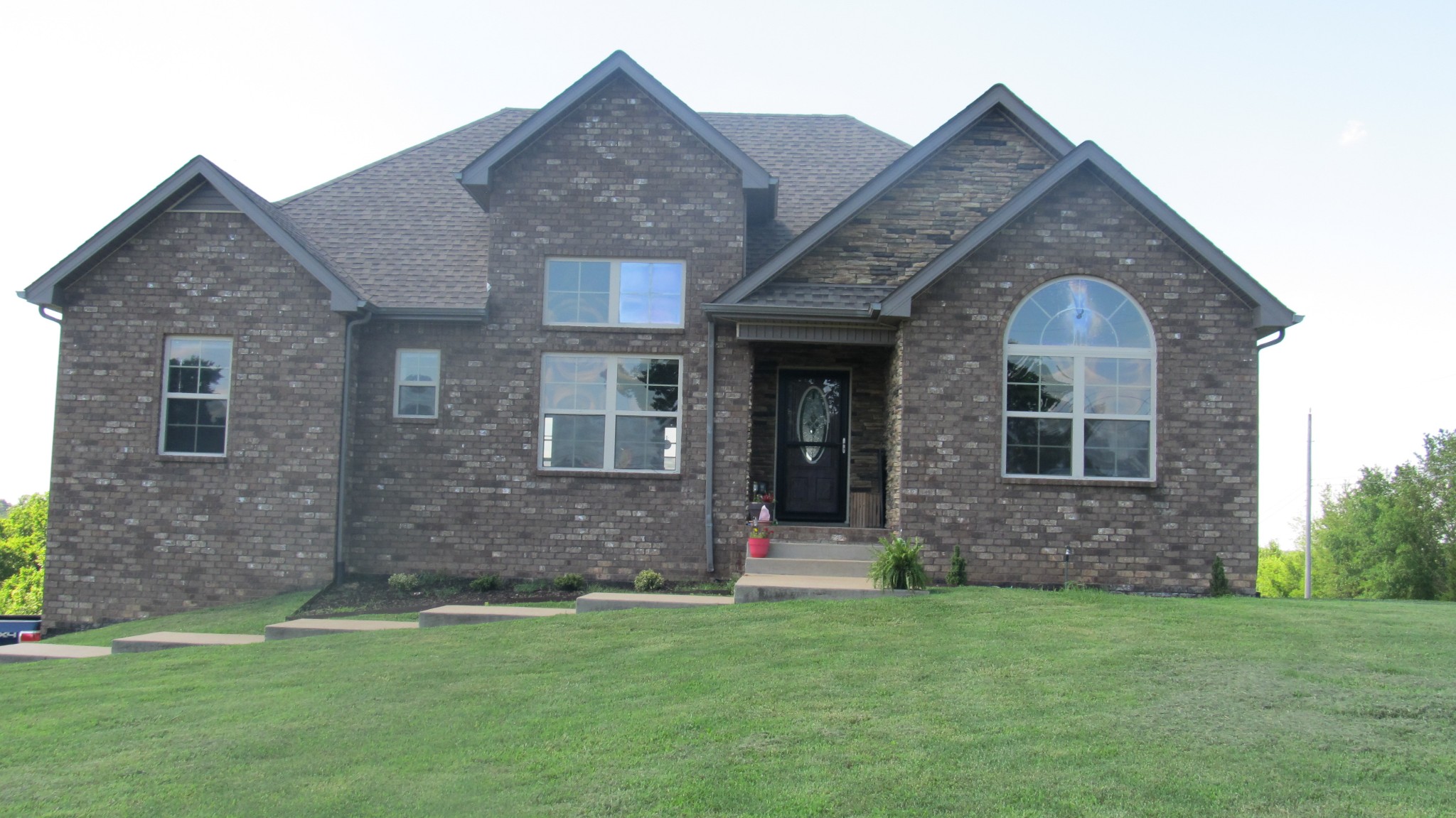 353 7 Mile Ferry Road Cunningham, TN 37052 - Photo 2 of 14 a front view of a house with a yard