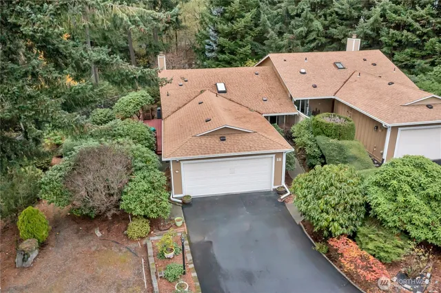 an aerial view of a house with a yard and garage