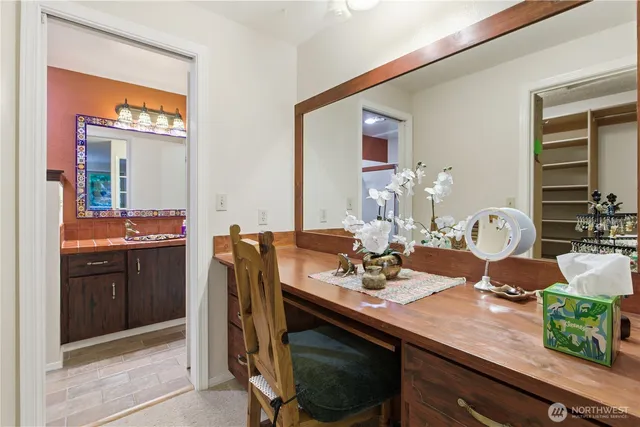 a bathroom with a toilet a sink a mirror and vanity