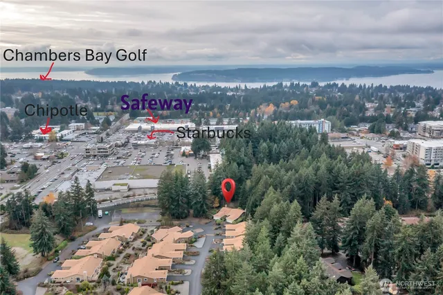 a balcony with wooden floor table and chairs
